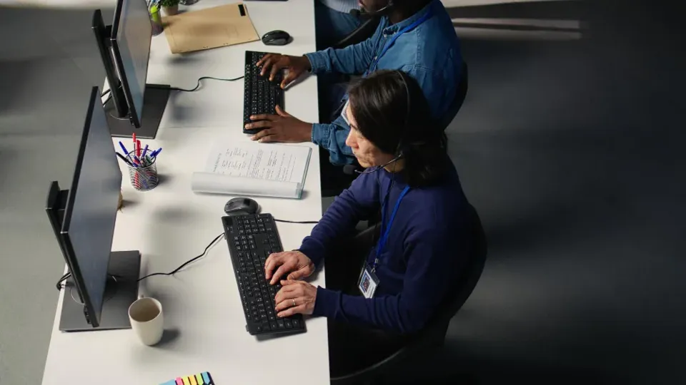 An IT support team at work on service desk calls