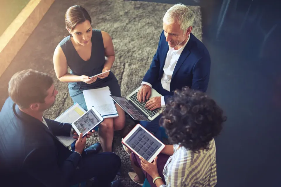 A team working outdoors on tablets