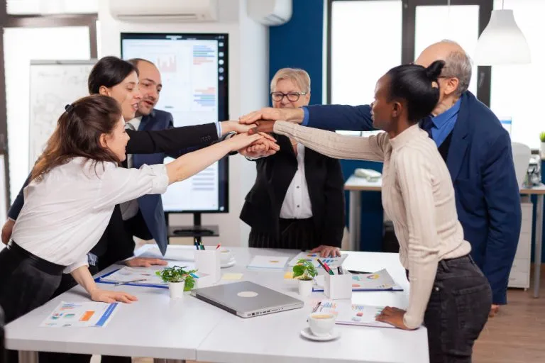 cheerful-overjoyed-business-people-conference-room-celerating-diverse-colleagues-with-new-opportunity-enjoing-victory-meeting-broadroom-office