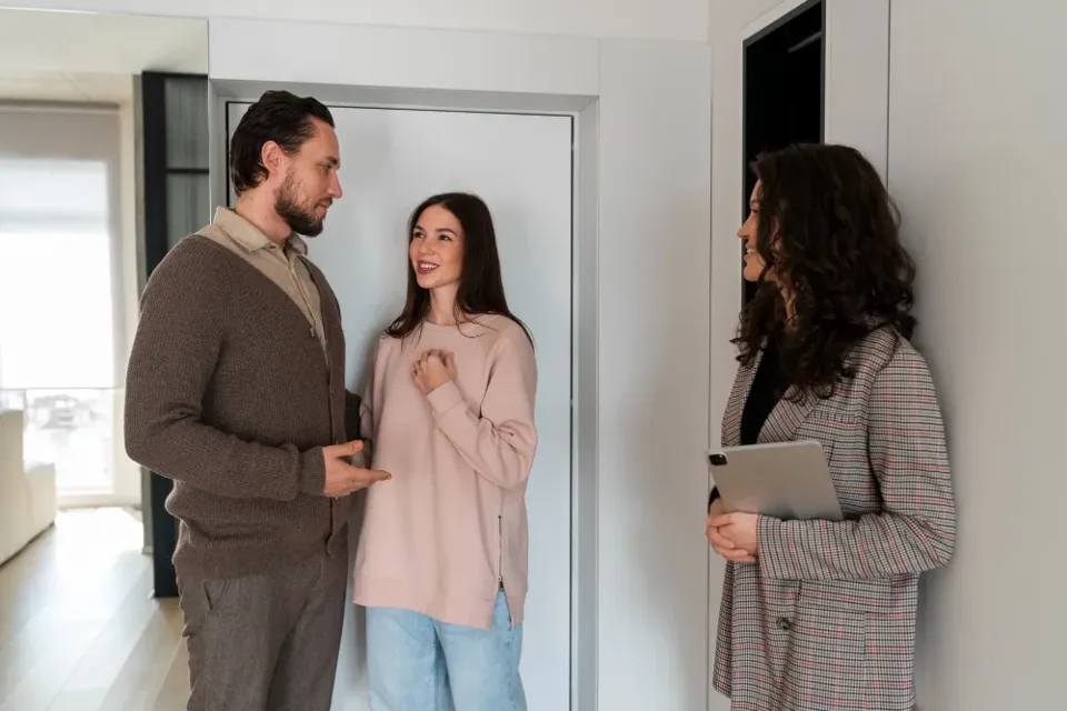 A housing officer showing a property to prospective tenants
