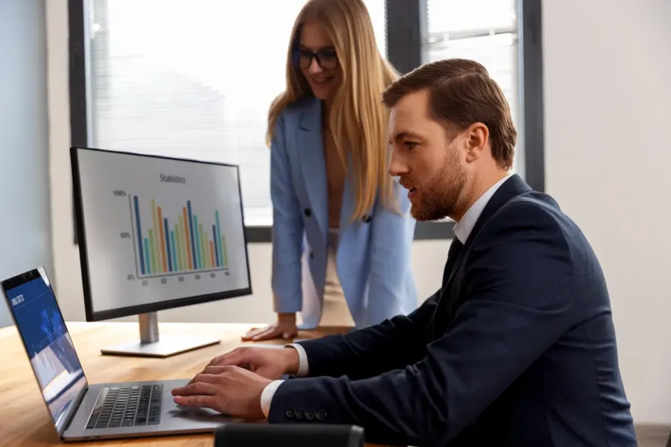 Two colleagues working through a dashboard