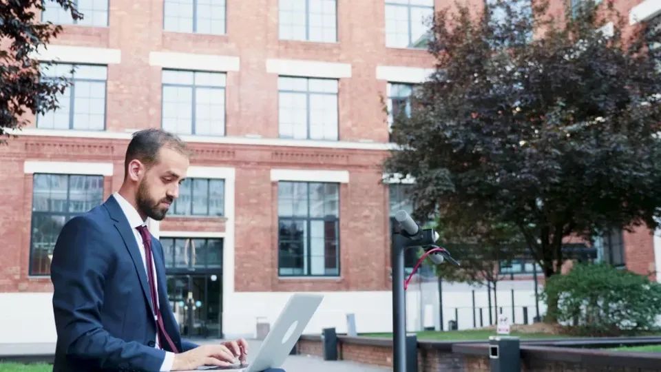 A property manager working through rent accounts on a laptop