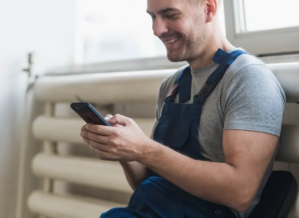 An operative checking a job on their phone
