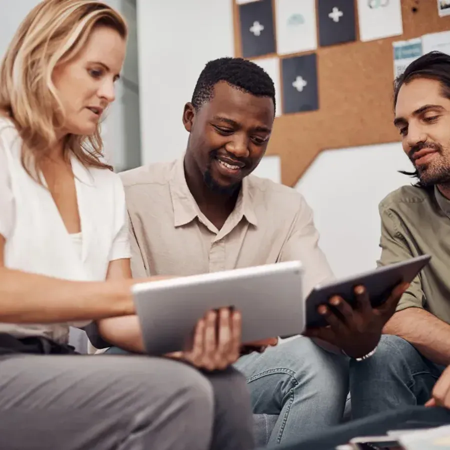 Colleagues gathered around tablets, asking their housing data a question together